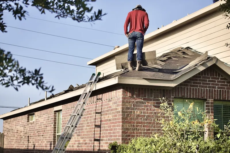 Professional roofer working on a residential roof in East Merrimack